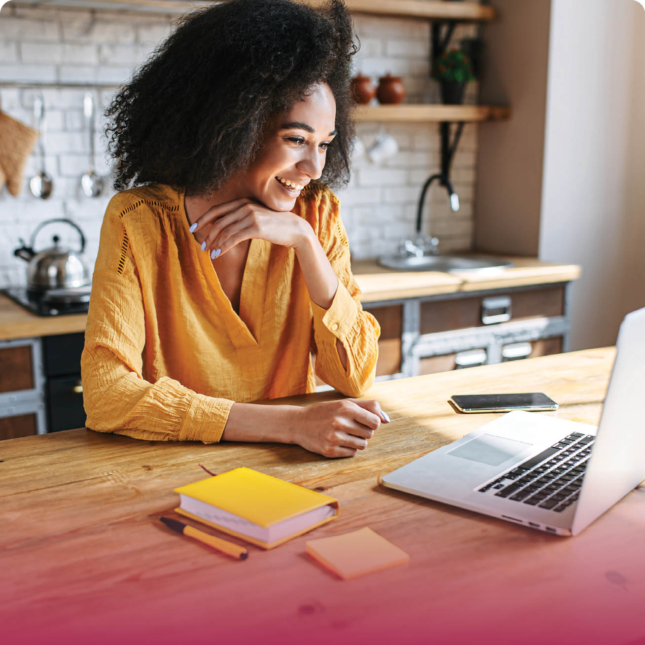 woman sitting at her kitchen counter working on a laptop